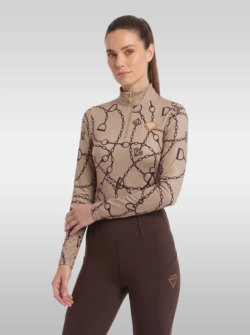 Beige Signature long sleeve base layer by Diamont Equestrian with chain and stirrup print, gold quarter-zip and gold diamond badge, front three-quarter view